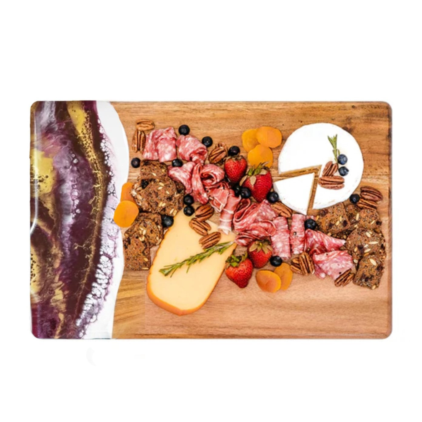 Wooden cutting board with assorted meats, cheeses, fruits, and nuts on a white background